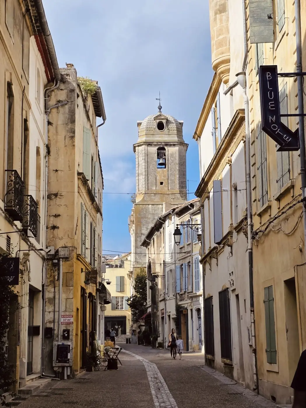 A narrow street in Arles leading to the bell tower of the old cathedral